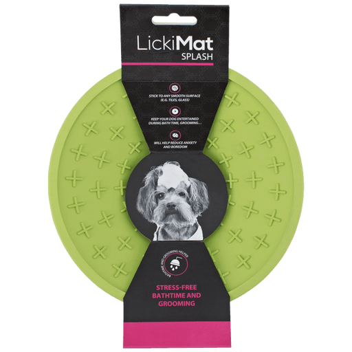 A green rubber bowl with plus signs inside and a packing band around the LickiMat.